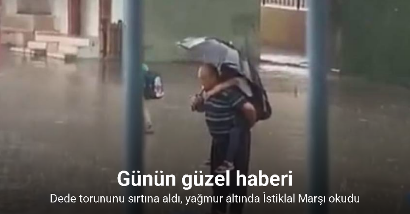 Dede torununu sırtına alarak yağmur altında İstiklal Marşı okudu