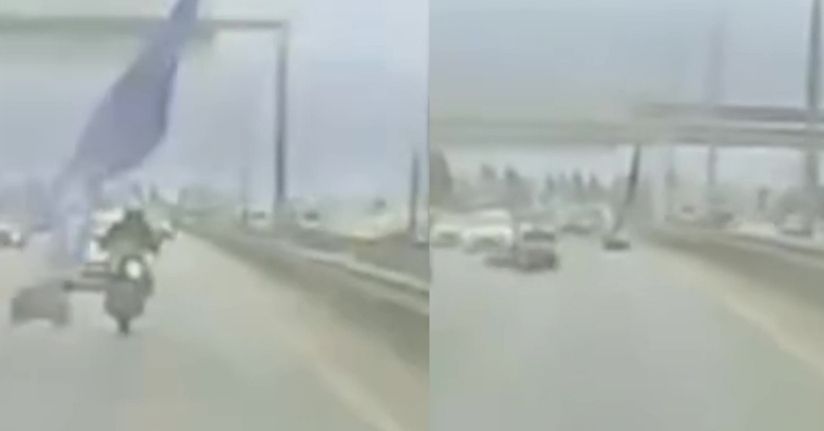 Köprüden sarkan reklam afişi motosikletliyi savurdu