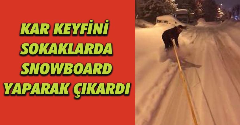Kar keyfini sokaklarda snowboard yaparak çıkardı
